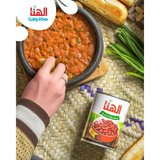 A can of hanaa red kidney beans with arabic label beside a bowl of middle eastern bean stew with rich taste red kidney beans