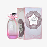 Pink gradient glass hareem al sultan perfume bottle with silver cap and pink ribbon beside ornate ard al zaafaran packaging floral touch