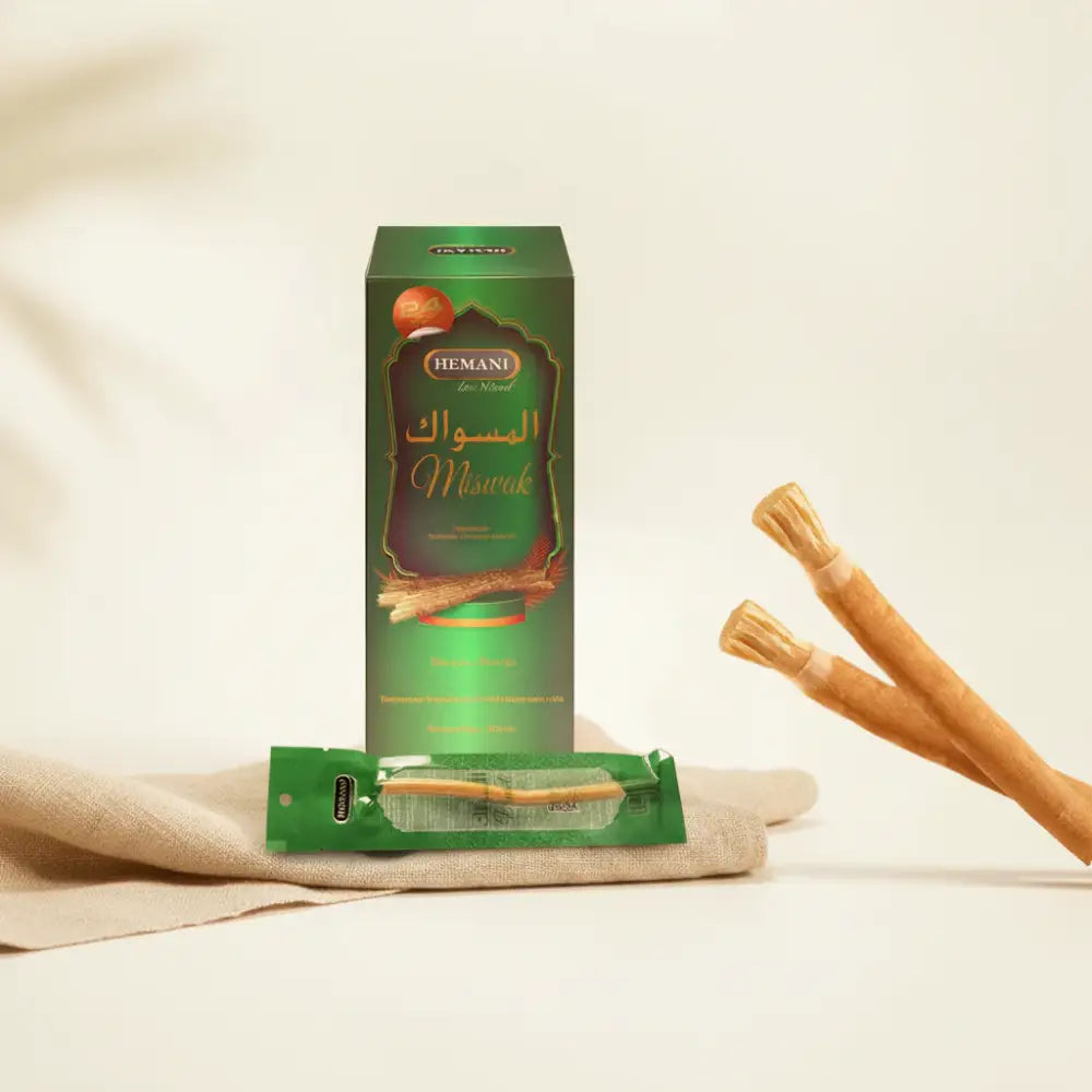HEMANI Miswak packaging with toothbrushes on a light green background
