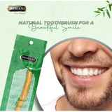 Hemani natural toothbrush packaging with a close-up of a smiling person's mouth.