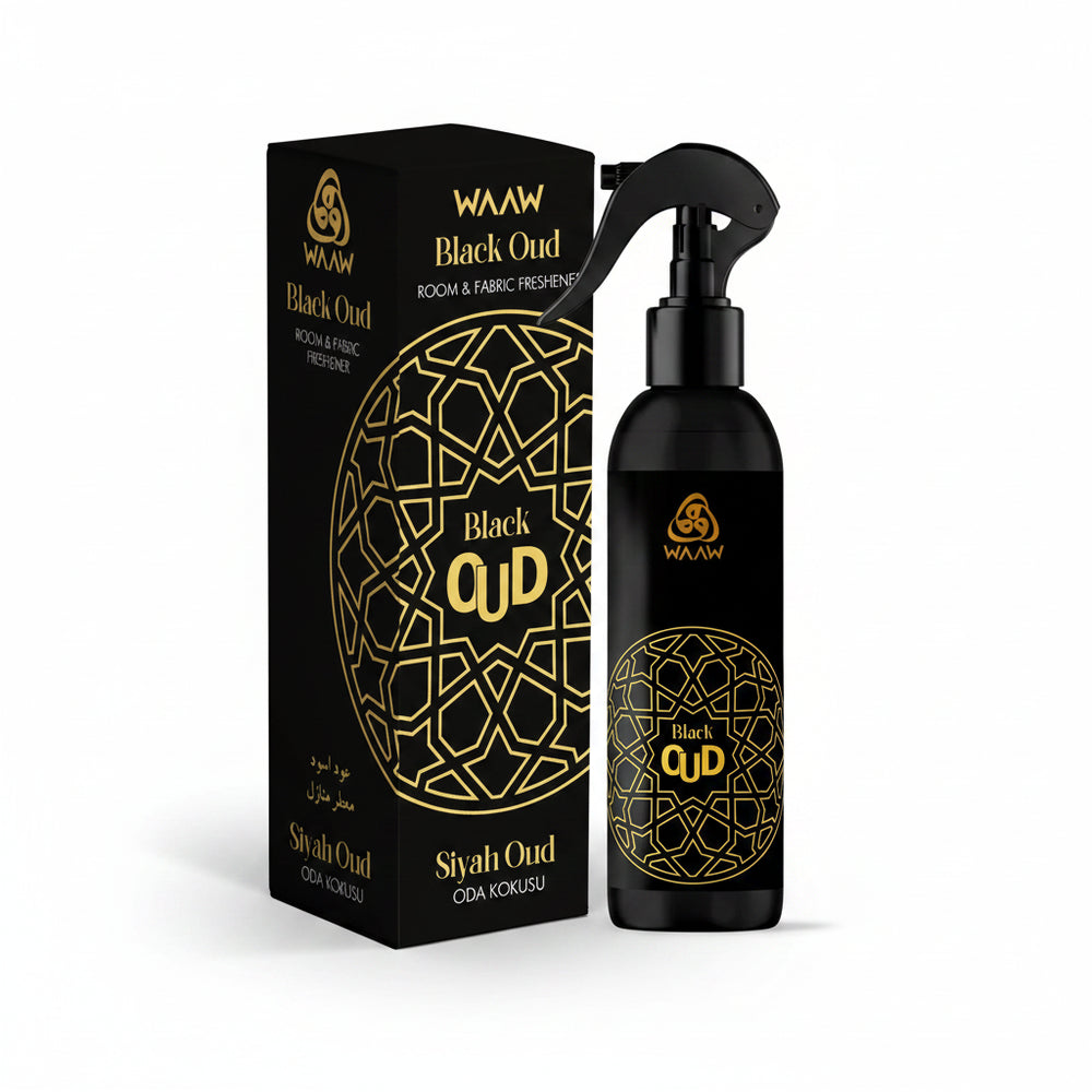 Black Oud room and fabric freshener spray bottle and its matching black packaging box, both featuring a gold geometric pattern and the brand name WAAW.