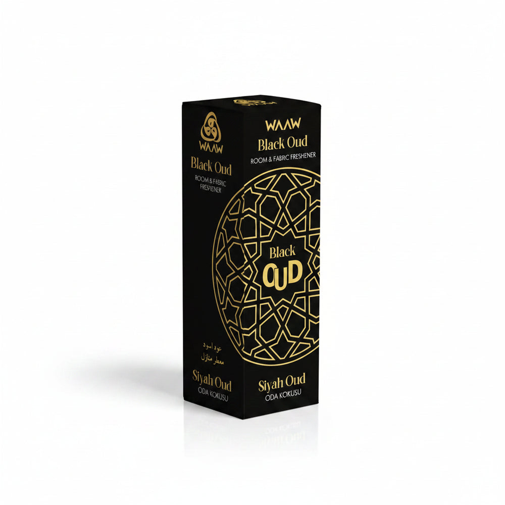 A tall rectangular black box for WAAW Black Oud room and fabric freshener, featuring gold text and an ornate circular geometric pattern on the front, shown on a plain white background.