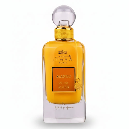 Golden-hued ithra dubai musk mango eau de parfum 100ml with clear glass body and ornate mango and musk label