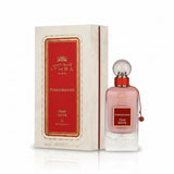 A pink glass perfume bottle with a red cap and clear stopper labeled ithra dubai musk pomegranate eau de parfum 100ml