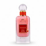 A pink glass perfume bottle of ithra dubai musk pomegranate eau de parfum 100ml with gold cap and red ribbon tie