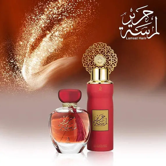 Two perfume bottles with gold and red design on a blurred background