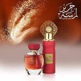 Two perfume bottles with gold and red design on a blurred background