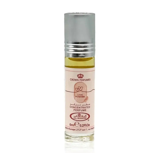 A small clear glass bottle with silver rollerball containing pale yellow love forever concentrated perfume oil by Al Rehab