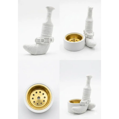 White ceramic bakhoor incense burner shaped like a traditional shoe with embossed patterns and gold interior base