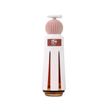 White and gold bottle with pink cap on a white background