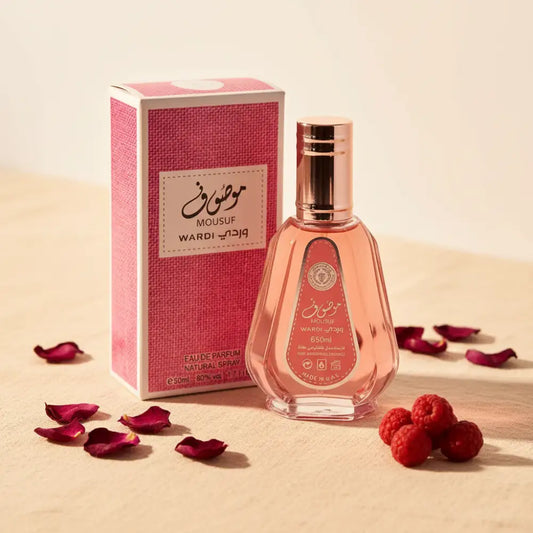 Pink perfume bottle and packaging with 'Mousuf Wardi' branding on a white background