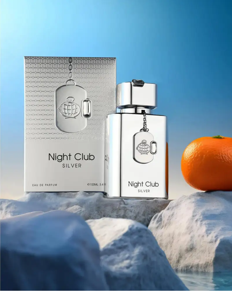 Silver 'Night Club Silver' perfume bottle and packaging with an orange on a blue background