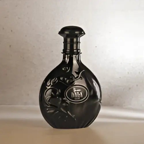 Black ceramic nyla suede edp 80ml bottle with intricate floral etching and matching stopper for suede woody fragrance