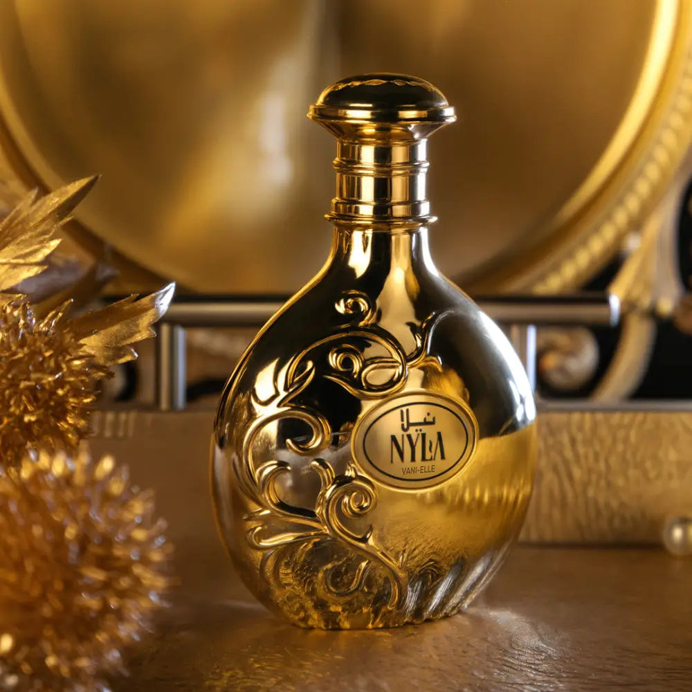 Golden nyla vani-elle arabiyat prestige parfum 80ml bottle with intricate swirling patterns and sleek reflective surface