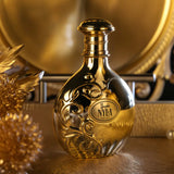 Golden nyla vani-elle arabiyat prestige parfum 80ml bottle with intricate swirling patterns and sleek reflective surface