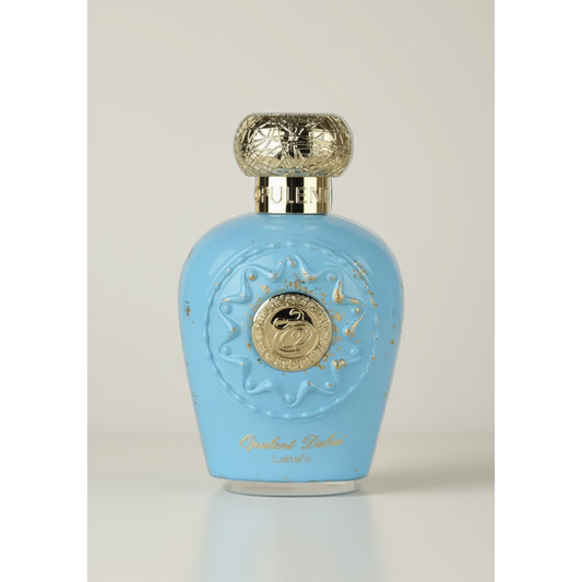 Blue perfume bottle with gold accents on a green background