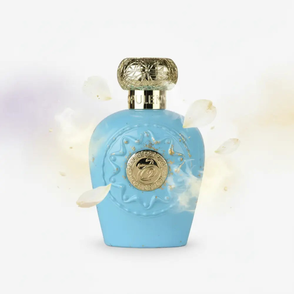 A light blue opulent dubai eau de parfum bottle with gold embossed cap and floral detailing featuring heart notes unisex fragrance