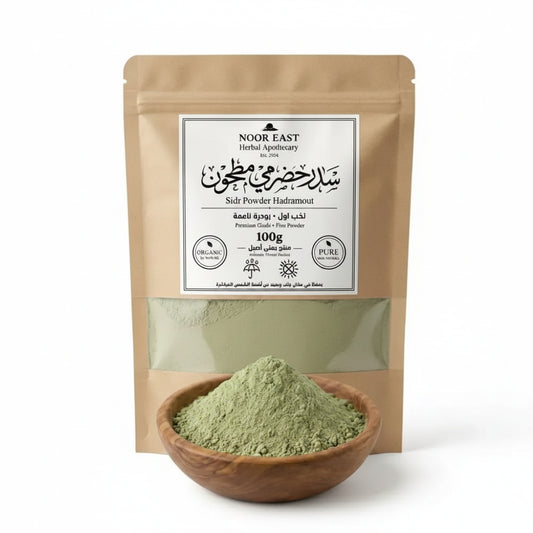 Herbal powder in a wooden bowl with a Noor East packaging on a white background