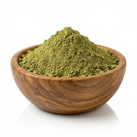A rustic wooden bowl filled with organic yemeni green matcha powder for body art quality hadramout henna use