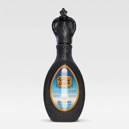 Black textured perfume bottle with ornate crown stopper and gold trim for original snake oil hair treatment 165ml