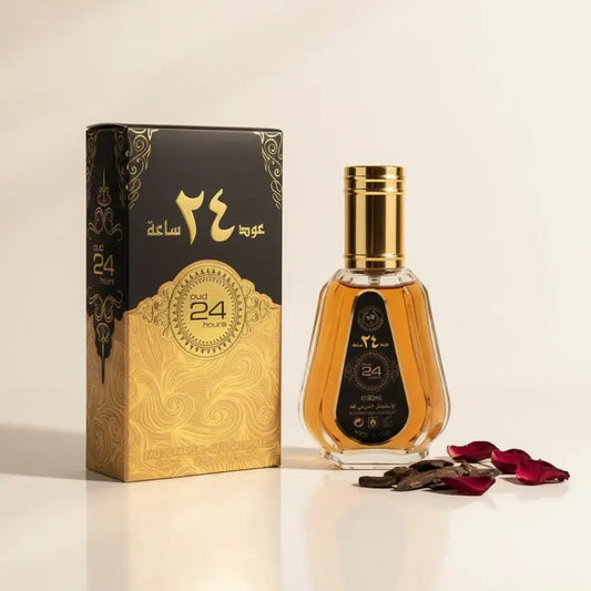 A golden-hued ard al zaafaran oud 24 hours eau de parfum bottle with a faceted glass body and ornate gold cap next to its black-and-gold box featuring pink pepper and tonka bean notes