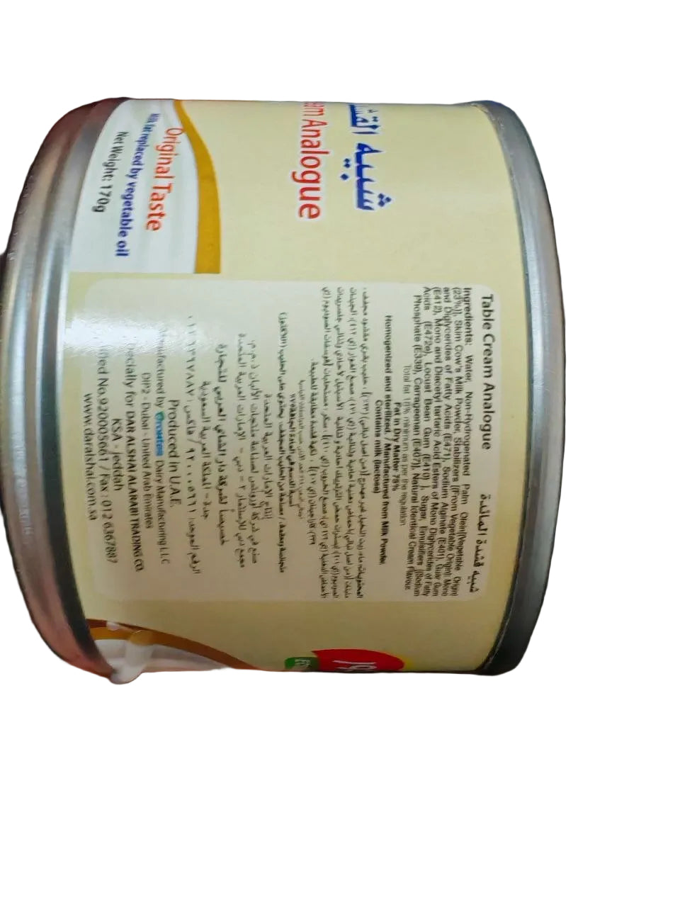 Hand holding a can of Unibene Evaporated Milk with visible text on the label.