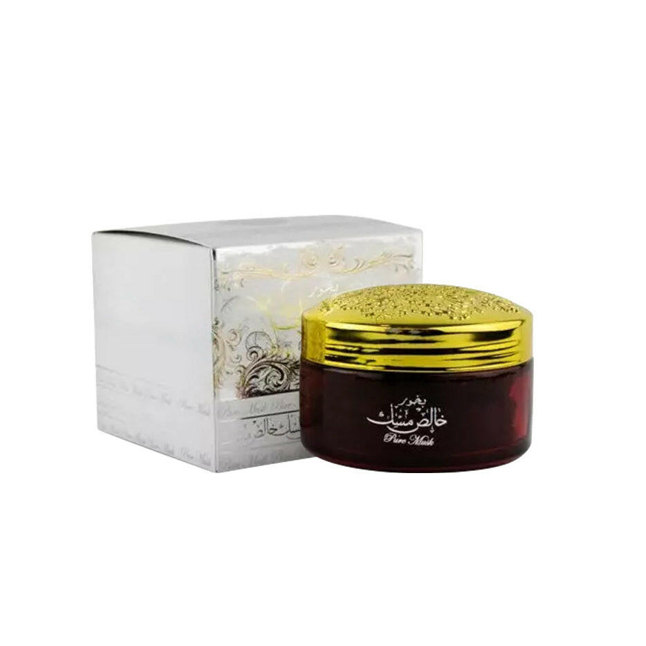 Jar of honey with a gold lid and decorative box on a white background