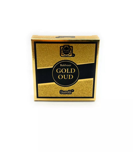 A square gold and black box of Bakhoor Gold Oud incense, featuring a glittery gold texture with a black horizontal band and central black circular label.