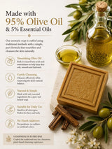Olive oil soap bar with olive oil bottle, cinnamon sticks, and olive branches on a light background.