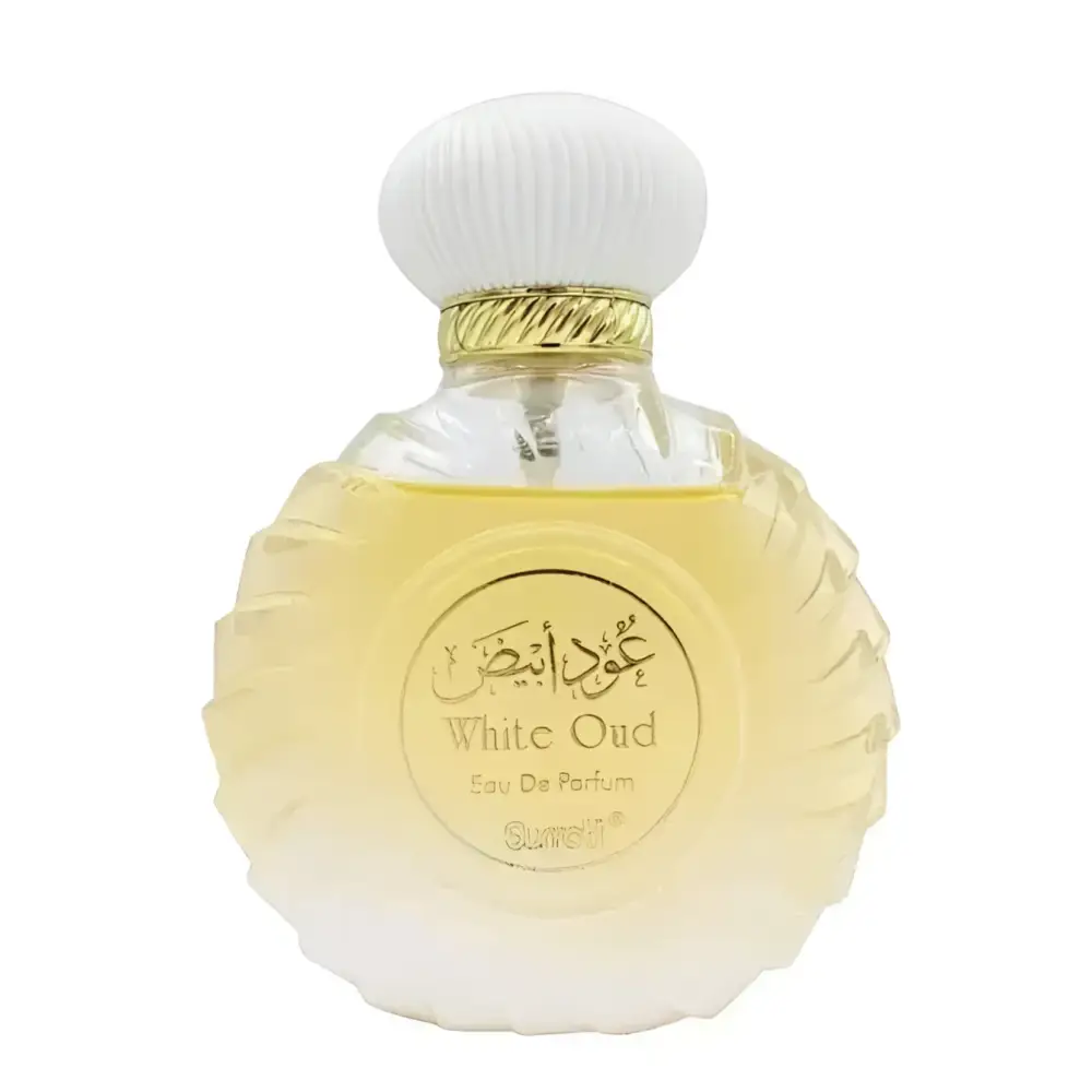 A clear glass bottle with fluted body and white ribbed cap containing white oud perfume from surrati oud collection