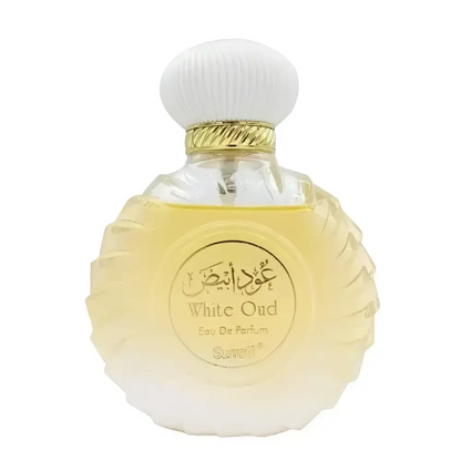 A clear glass bottle with fluted body and white ribbed cap containing white oud perfume from surrati oud collection