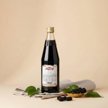 A clear glass bottle of vimto arabic fruit cordial syrup filled with dark red liquid and a gold cap