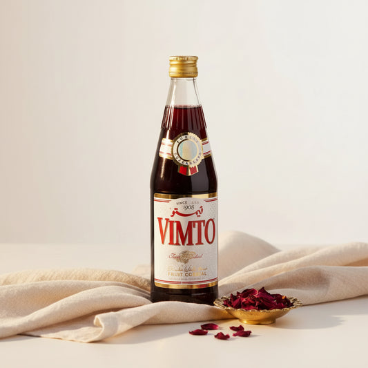 Vimto arabic fruit cordial syrup in a dark red glass bottle with gold cap and white label for Ramadan drink