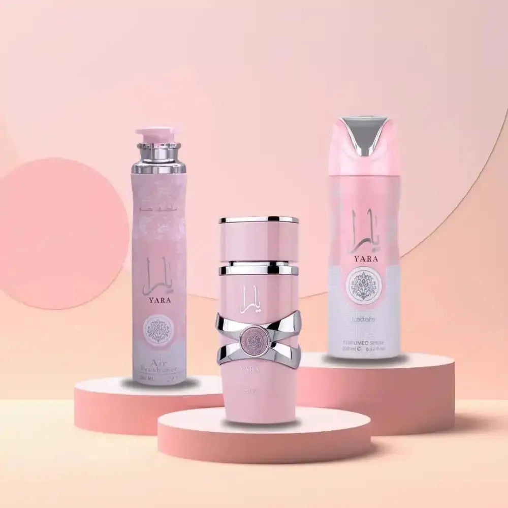 Three pink skincare products with silver accents on a pink background
